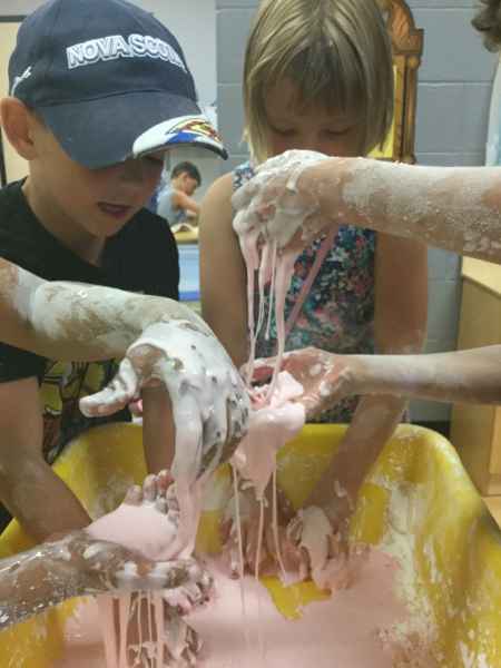 children using their hands to play with slime